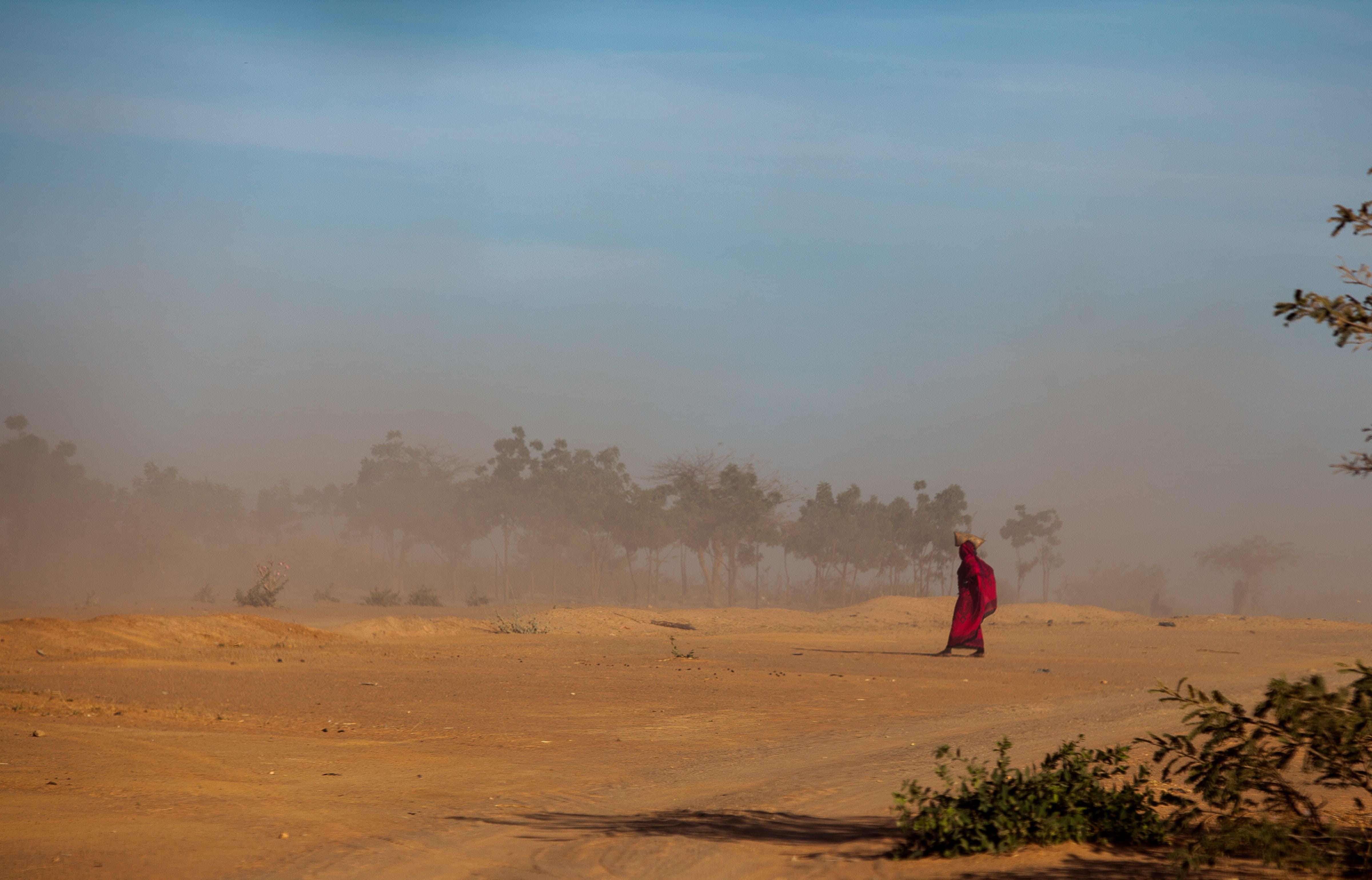 A woman walking in an arid climate