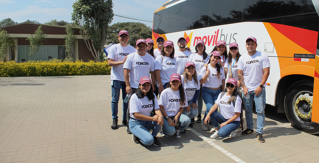 A group of people next to a bus